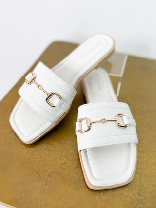 white slide sandal with horse bit detail 