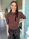 brown sweater with black bow 