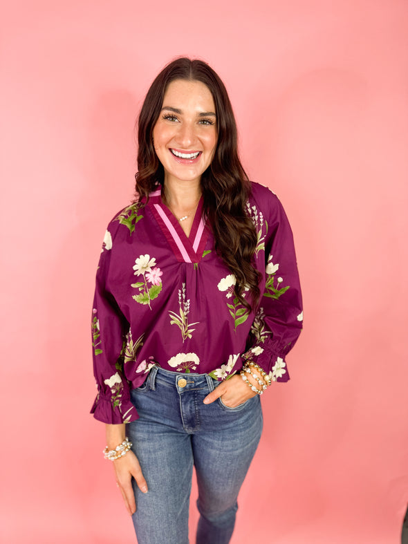 plum colored top with floral 

