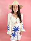 white dress with blue embroidered palm trees