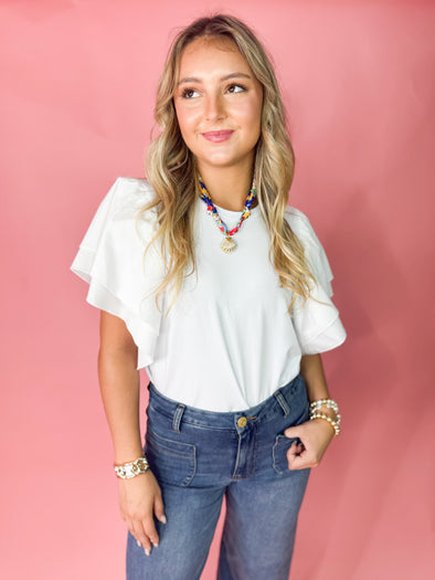 white top with ruffle sleeves