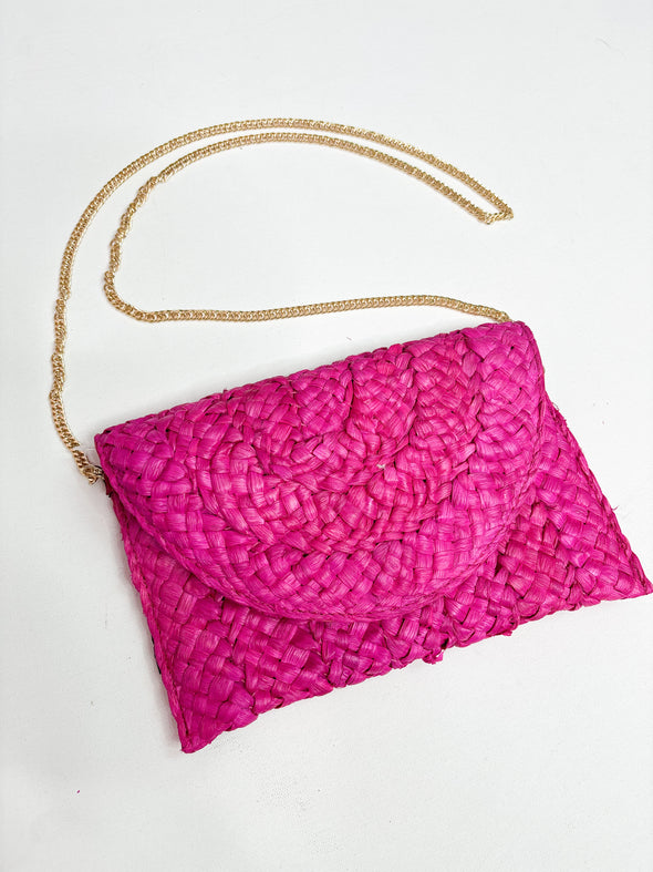 pink raffia clutch with gold chain 