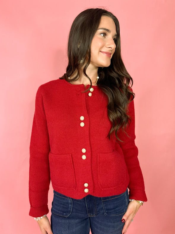 red cardigan with pearl buttons