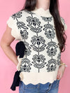 scallop black and cream sweater with black bow ties at the side 