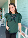 hunter green top with embellished bow detail 