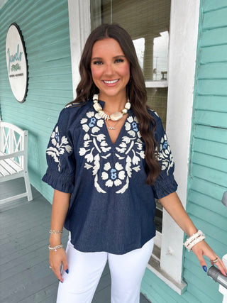 denim top with white embroidery 