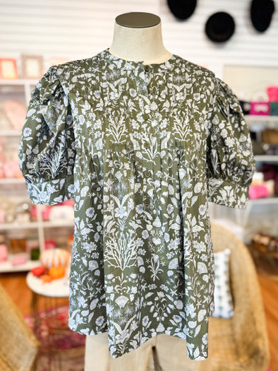olive top with withe floral 
