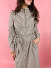 close up of brown gingham dress