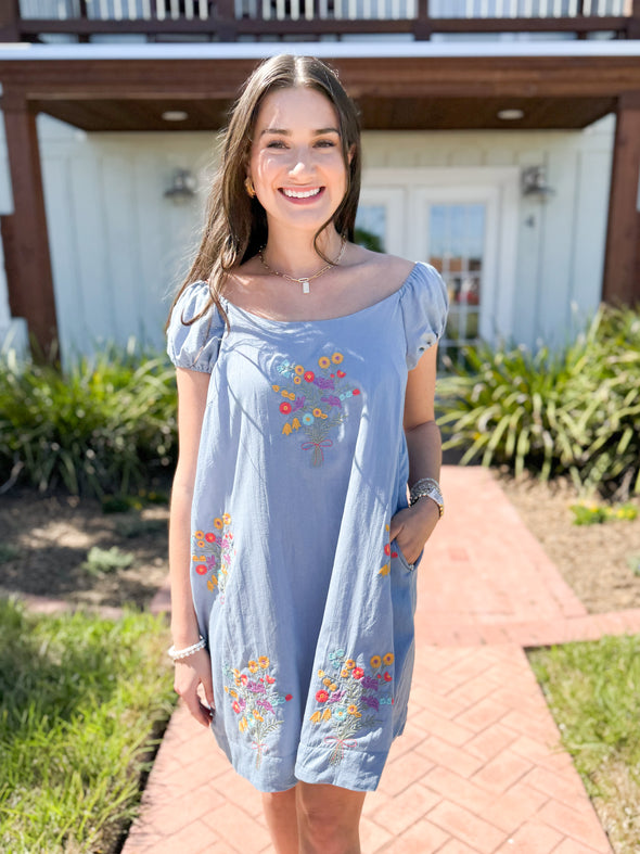 blue dress with embroidered flowers